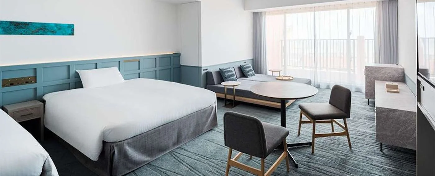 Lequ Okinawa Chatan Spa and Resort guest room with king bed and balcony