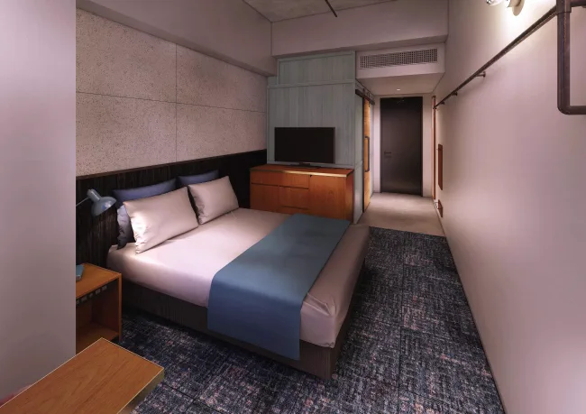 Chambre double de The HOTEL Well-hub Haneda avec lit et bureau