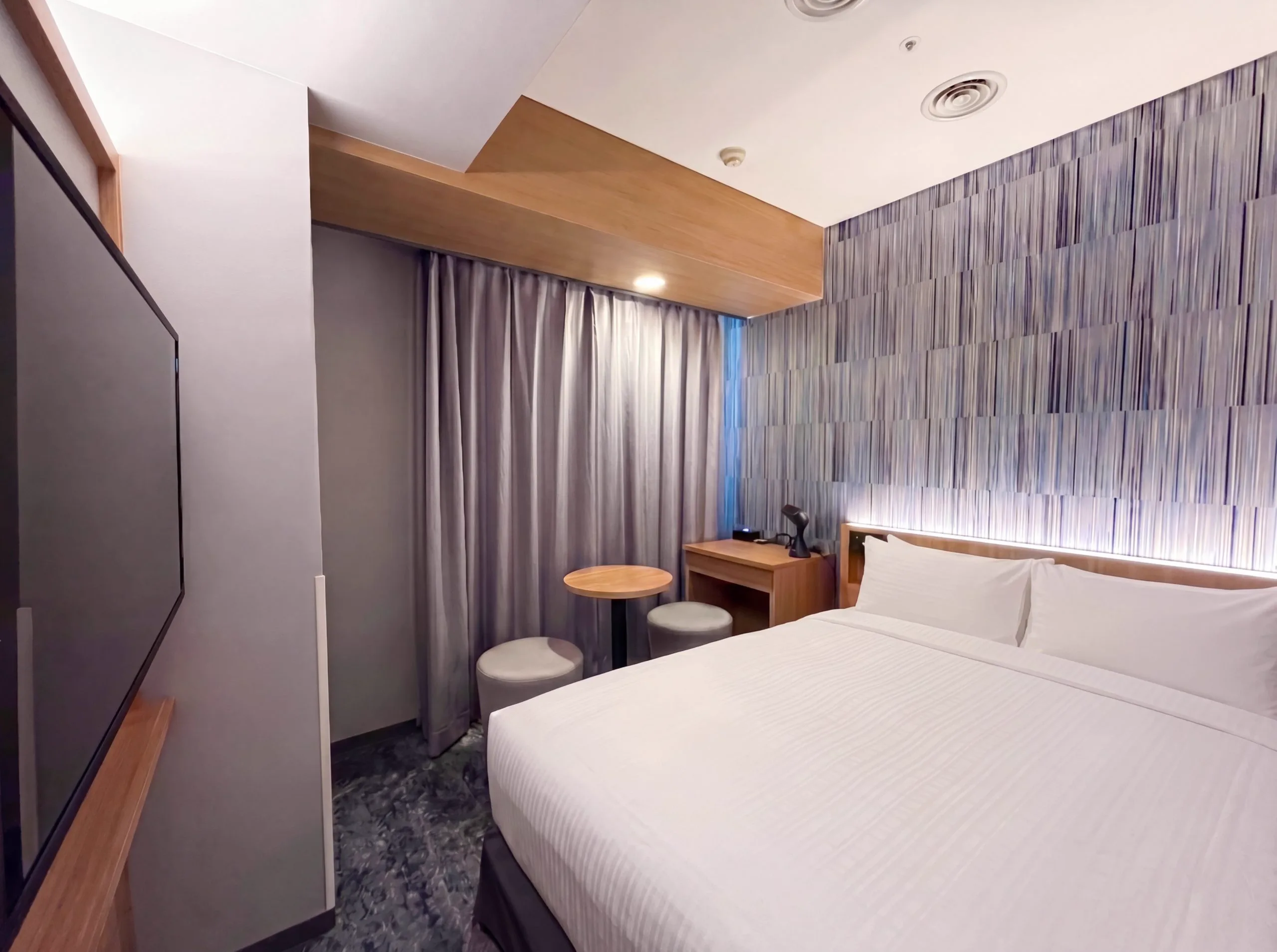 Chambre et lit à l'hôtel Gracery Sapporo