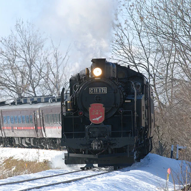 Train JR Hokkaido dans un paysage enneigé, rappelant le temps consommé par les longues liaisons